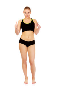 Portrait of young woman standing against white background