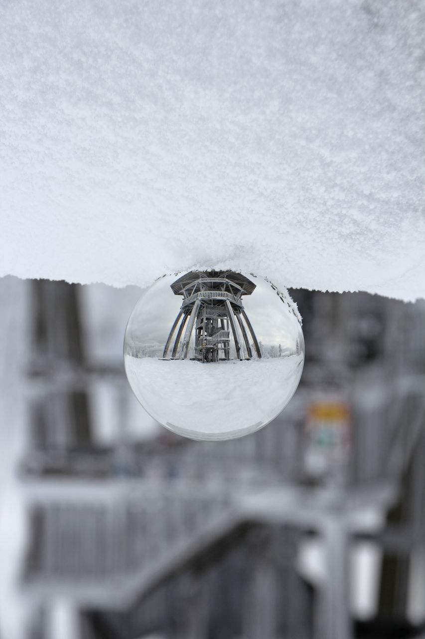 CLOSE-UP OF CRYSTAL BALL HANGING AGAINST SKY