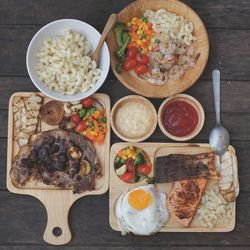 High angle view of meal served on wooden table