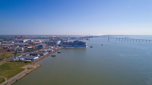 High angle view of sea and cityscape against sky