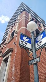 Low angle view of road sign against building