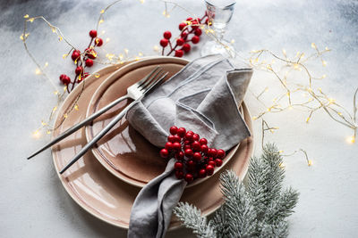 Festive place setting for celebration the christmas eve on concrete table