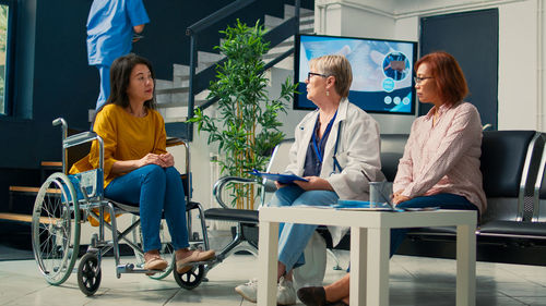 Portrait of doctor explaining to patient in office