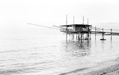 Lifeguard hut in sea against clear sky