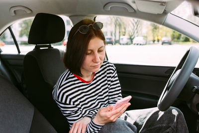 Portrait of woman sitting in car