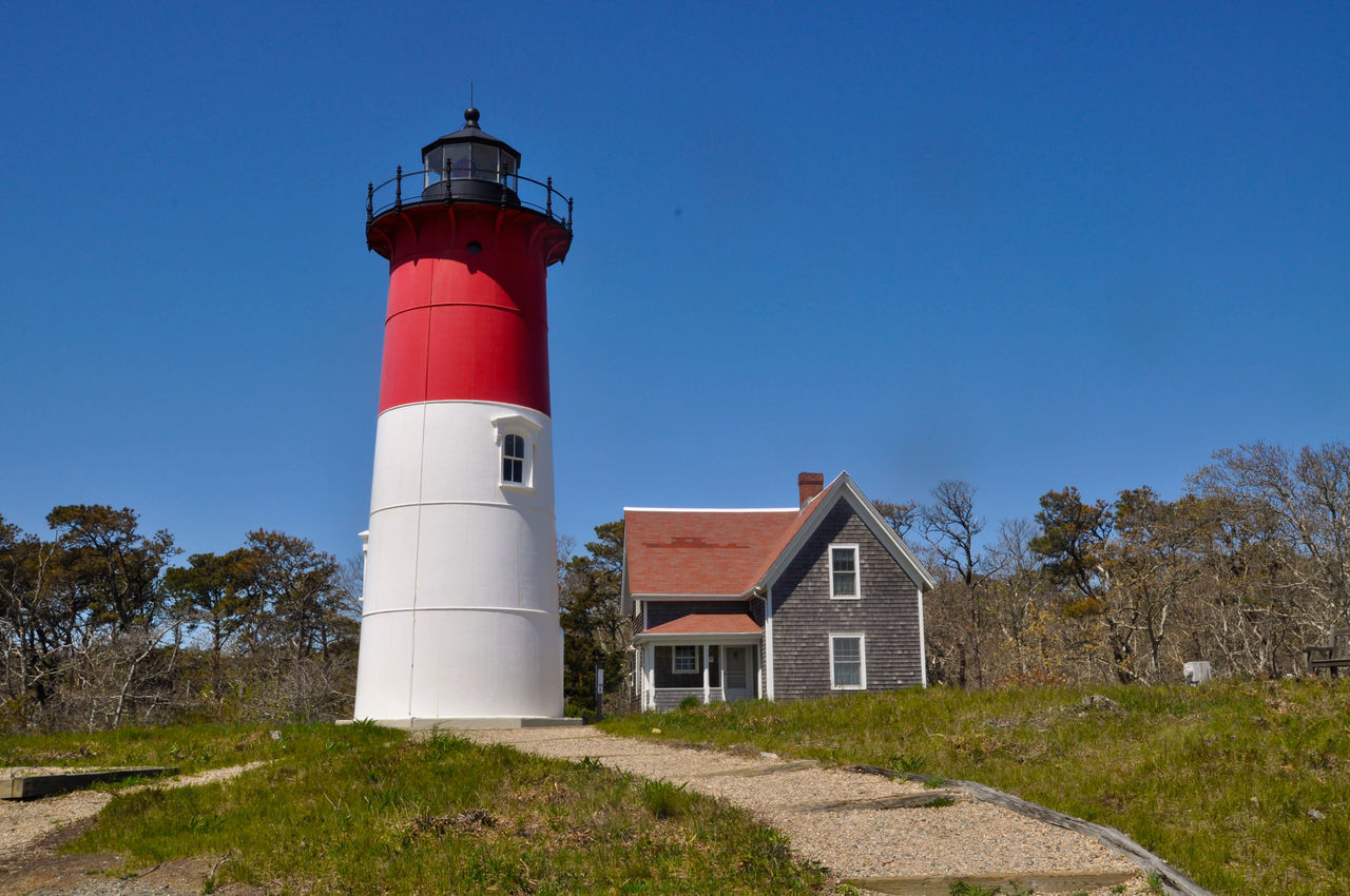 lighthouse, building exterior, built structure, architecture, guidance, direction, protection, safety, clear sky, blue, low angle view, security, tower, red, outdoors, tall, no people, green color