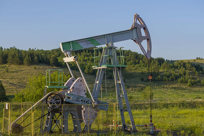 Working oil pump from oil field. industrial equipment. bashkortostan, russia - 12 june, 2021.