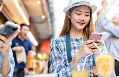 Portrait of young woman using mobile phone