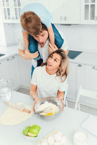 High angle view of cute girl playing in kitchen