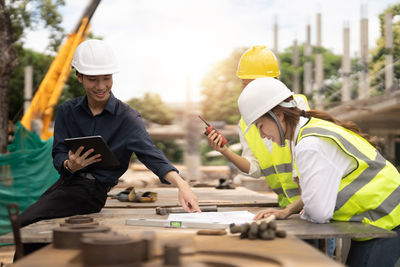 Rear view of people working at construction site