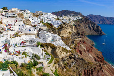 High angle view of townscape by sea against sky