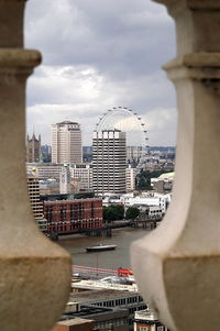 Buildings against cloudy sky