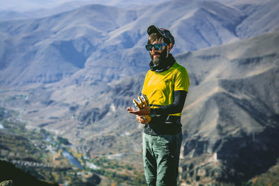 Rear view of man standing on mountain