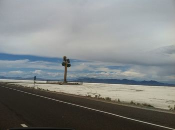 Road by sea against sky