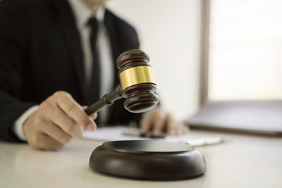 Close-up of a hand holding tea cup on table