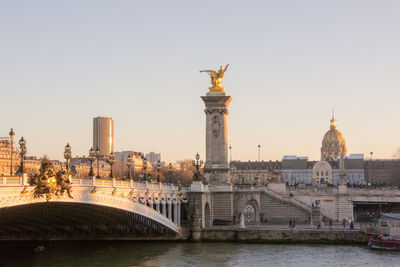 View of pont alexandre iii and les invalides at sunset in paris, france