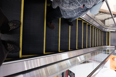 Low section of person on escalator