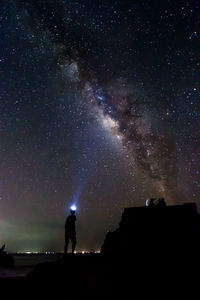 Silhouette of man against sky at night