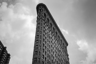 Low angle view of building against cloudy sky