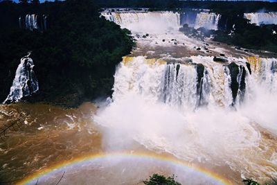 Scenic view of waterfall against sky