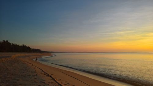 Scenic view of beach against sky during sunset