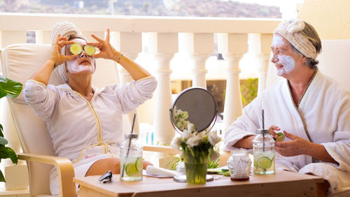 Females with facial masks sitting in balcony