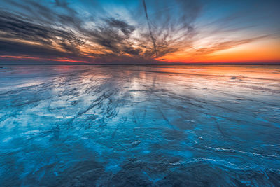 Scenic view of sea against sky at sunset