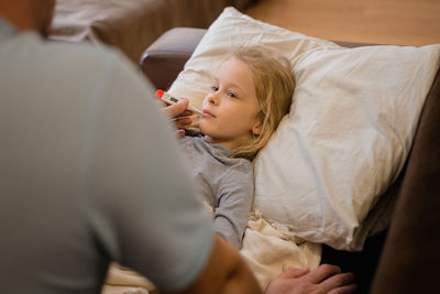 High angle view of doctor examining patient in hospital