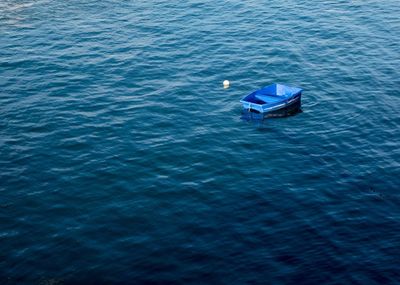 High angle view of boat sailing in sea