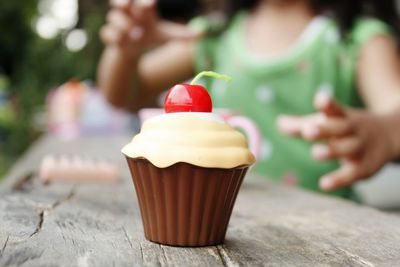 Close-up of fake cup cake on table