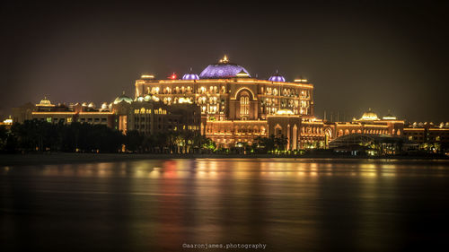 Illuminated building against sky at night