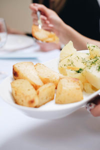 Close-up of woman holding food in plate