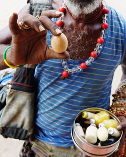 Midsection of man holding fruits in basket