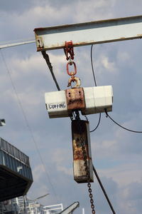 Low angle view of old telephone pole against sky