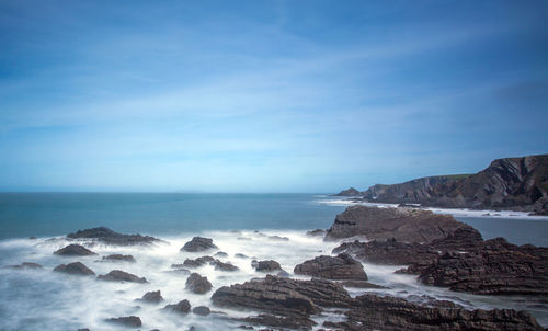 Scenic view of sea against clear blue sky