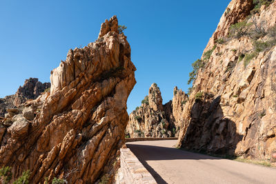 View of rock formations against blue sky