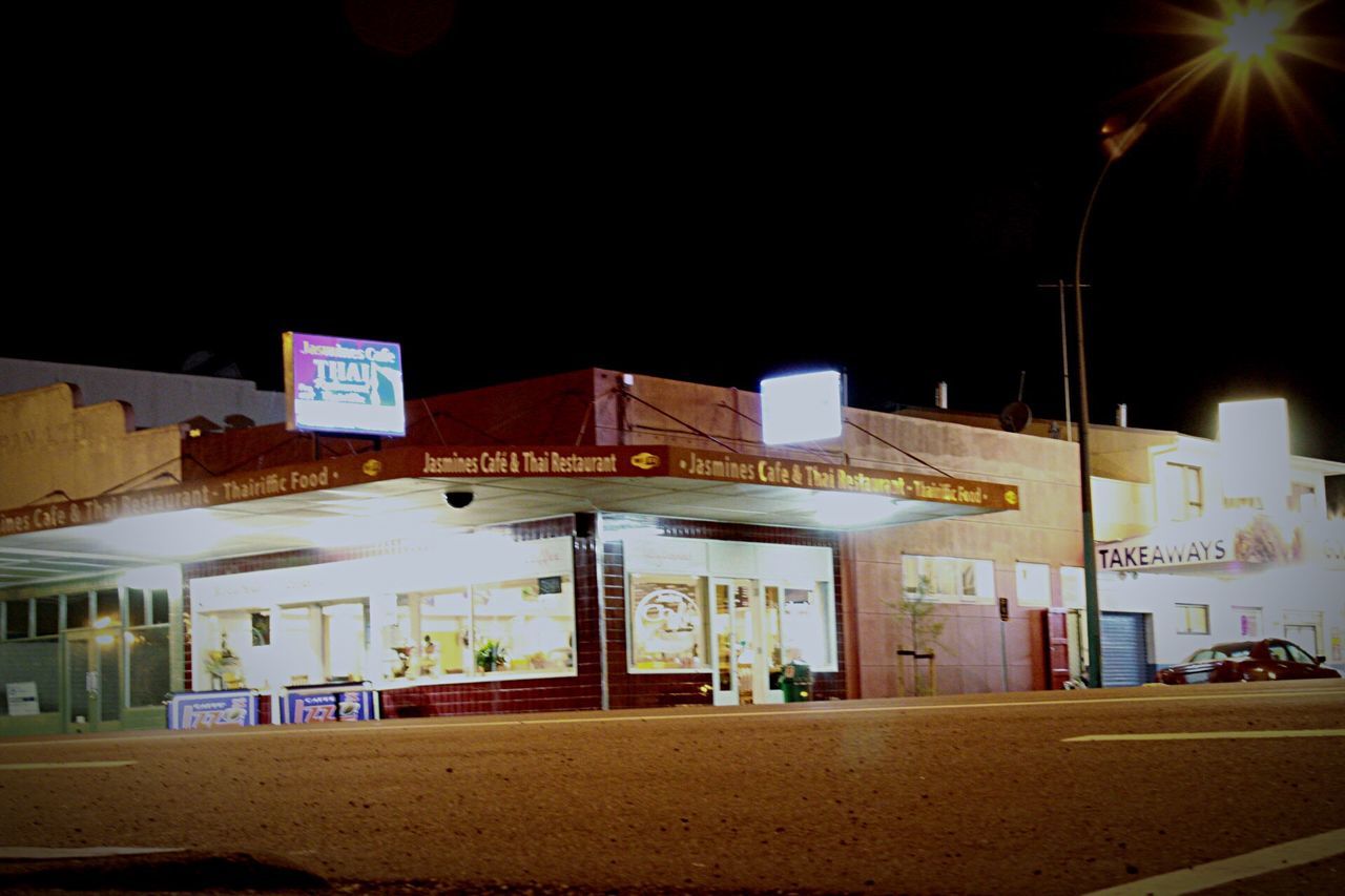 illuminated, night, architecture, built structure, building exterior, text, street, street light, lighting equipment, western script, clear sky, city, road, copy space, communication, outdoors, no people, transportation, sign, incidental people