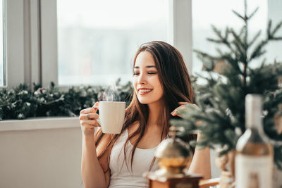 Young woman drinking coffee cup