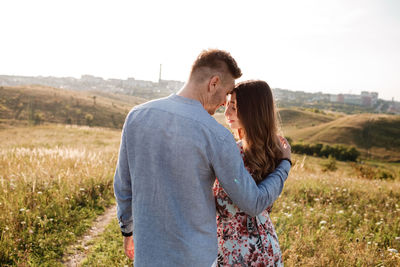 Young couple standing on field