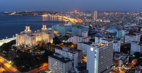 High angle view of city lit up at night