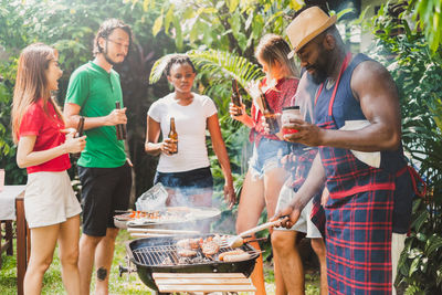 Group of people standing on barbecue grill