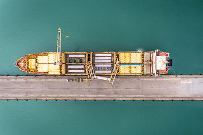 Aerial top view container ship with crane bridge for load container.