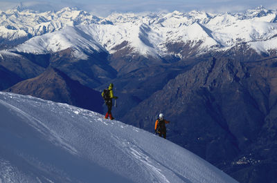 People on snowcapped mountains during winter