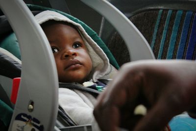 Portrait of cute girl sitting in car