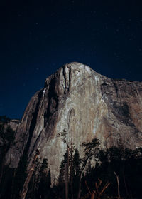 Low angle view of rock formations at night