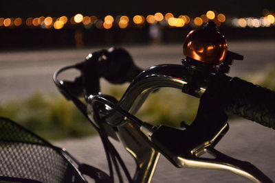 Close-up of bicycle on street at night