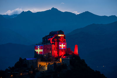 View of illuminated buildings in city at dusk