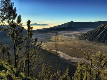 Scenic view of landscape and mountains against clear blue sky