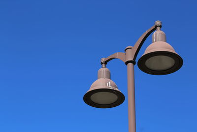 Low angle view of street light against clear blue sky