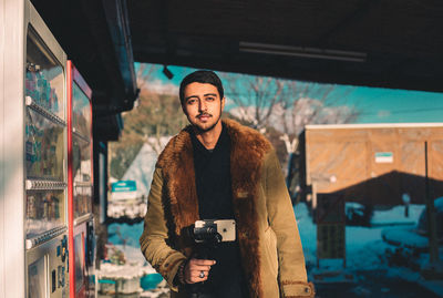 Portrait of young man photographing